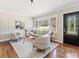 Cozy living room with hardwood floors, large windows, comfortable seating, and stylish decor at 1703 Derrill Dr, Decatur, GA 30032
