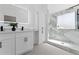 A stylish bathroom with double sinks, a lighted mirror, and a glass-enclosed shower at 382 Deckner Sw Ave, Atlanta, GA 30310