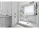 This bright bathroom includes white marble-look tile and a glass-enclosed shower at 382 Deckner Sw Ave, Atlanta, GA 30310