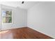 An empty bedroom featuring a window providing natural light and beautiful hardwood floors at 382 Deckner Sw Ave, Atlanta, GA 30310