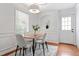 Bright dining room with wood floors, and a table set for four beneath a modern light fixture at 382 Deckner Sw Ave, Atlanta, GA 30310