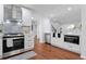 Updated kitchen featuring stainless steel appliances and white cabinets; open to living area at 382 Deckner Sw Ave, Atlanta, GA 30310