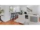 Inviting living space with bar stools, hardwood floors, and views of the modern kitchen at 382 Deckner Sw Ave, Atlanta, GA 30310