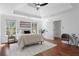 This spacious bedroom features a tray ceiling, hardwood floors, neutral decor, and large windows at 382 Deckner Sw Ave, Atlanta, GA 30310