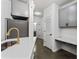 Well-lit kitchen featuring gray cabinets, a faucet, and access to a bathroom at 400 17Th Nw St # 1133, Atlanta, GA 30363