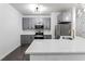 Modern kitchen with stainless steel appliances, quartz countertops, and gray cabinets at 400 17Th Nw St # 1133, Atlanta, GA 30363