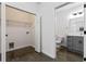 Laundry room includes washer/dryer hookups, storage shelves, and sink with modern fixtures next to a bathroom at 400 17Th Nw St # 1133, Atlanta, GA 30363