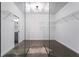 A generously sized walk-in closet with shelving units visible behind glass partition at 400 17Th Nw St # 1133, Atlanta, GA 30363