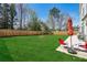 Large, well-manicured backyard with a wood fence and patio furniture at 4257 Freight St, Tucker, GA 30084