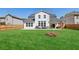Backyard with large manicured lawn, wood fence, patio, and outdoor furniture at 4257 Freight St, Tucker, GA 30084
