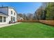 Large manicured backyard with a wood fence and patio with outdoor furniture at 4257 Freight St, Tucker, GA 30084