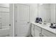 All white bathroom with walk in shower, white cabinets, drawers, white quartz countertops, and stainless steel faucet at 4257 Freight St, Tucker, GA 30084