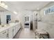 Bright bathroom with double vanity, shower and view to main bedroom at 4257 Freight St, Tucker, GA 30084