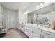 Bright bathroom with double vanity, white cabinetry, and a large mirror at 4257 Freight St, Tucker, GA 30084
