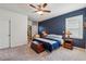Bedroom with a blue accent wall, carpet flooring, and ample natural light at 4257 Freight St, Tucker, GA 30084
