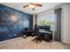 Bedroom with a galaxy mural, ceiling fan, large windows, and black desk setup for gaming at 4257 Freight St, Tucker, GA 30084