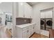 Convenient butler's pantry with ample cabinet space and a view into the laundry area at 4257 Freight St, Tucker, GA 30084