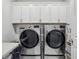 Well-equipped laundry room featuring modern, stainless steel washer and dryer units and ample storage at 4257 Freight St, Tucker, GA 30084