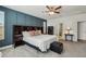 Spacious main bedroom featuring an accent wall, carpet flooring, and a ceiling fan at 4257 Freight St, Tucker, GA 30084