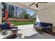 Covered patio features a ceiling fan, pavers, and outdoor furniture with a view of the fenced backyard at 4257 Freight St, Tucker, GA 30084