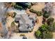 Overhead shot of a well-maintained home with a large roof, surrounded by landscaping and hardscape at 1037 Windermere Xing, Cumming, GA 30041