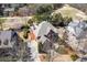 An aerial shot of a beautiful home with mature trees and landscaping in a desirable neighborhood near a golf course at 1037 Windermere Xing, Cumming, GA 30041