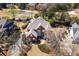 Bird's eye view of a stately home with mature trees and landscaping, showcasing curb appeal at 1037 Windermere Xing, Cumming, GA 30041