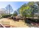 Beautiful backyard with landscaping, trees, grass, and wrought iron fence at 1037 Windermere Xing, Cumming, GA 30041