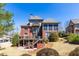 A two-story brick home featuring a large deck and patio surrounded by a lush landscaped yard at 1037 Windermere Xing, Cumming, GA 30041