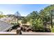 Balcony with scenic views of tree tops, lush landscaping, and a golf course at 1037 Windermere Xing, Cumming, GA 30041