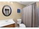 Bathroom featuring a wooden vanity, toilet, and shower with a curtain at 1037 Windermere Xing, Cumming, GA 30041
