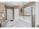 Bright bathroom featuring a soaking tub, tiled floors, and a separate shower at 1037 Windermere Xing, Cumming, GA 30041
