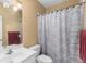 Bright bathroom featuring a patterned shower curtain and classic vanity at 1037 Windermere Xing, Cumming, GA 30041