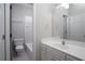 This bathroom has a vanity with a white countertop and access to the shower and toilet at 1037 Windermere Xing, Cumming, GA 30041