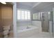 Relaxing bathroom features a soaking tub with tiled surround and a glass-enclosed shower at 1037 Windermere Xing, Cumming, GA 30041