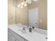 Bathroom with a single sink vanity, large mirror, and overhead lighting at 1037 Windermere Xing, Cumming, GA 30041