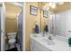 Bathroom with a single sink vanity, large mirror, and a toilet next to the shower at 1037 Windermere Xing, Cumming, GA 30041