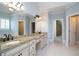 Bright bathroom featuring double vanities, granite countertops, and neutral tiling at 1037 Windermere Xing, Cumming, GA 30041