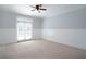 Bright and airy bedroom featuring neutral paint, carpet flooring and double doors at 1037 Windermere Xing, Cumming, GA 30041