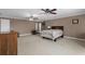 Large primary bedroom with carpet flooring, ceiling fans, and natural light at 1037 Windermere Xing, Cumming, GA 30041