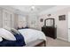 Bright bedroom featuring a bed, windows, carpet and a ceiling fan at 1037 Windermere Xing, Cumming, GA 30041