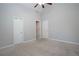 Bedroom features neutral paint, carpet, and multiple closets at 1037 Windermere Xing, Cumming, GA 30041