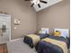Cozy bedroom featuring two twin beds, vaulted ceiling, and a view of the hallway at 1037 Windermere Xing, Cumming, GA 30041