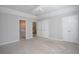Spacious bedroom with carpet, ceiling fan, and multiple doors at 1037 Windermere Xing, Cumming, GA 30041