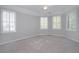 Bedroom featuring neutral walls, carpet, ceiling fan and multiple windows, creating an inviting atmosphere at 1037 Windermere Xing, Cumming, GA 30041