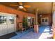Inviting covered patio with brick flooring, ceiling fans, and comfortable seating area for relaxation at 1037 Windermere Xing, Cumming, GA 30041