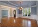 Formal dining room boasting hardwood floors, chandelier lighting, and detailed crown molding at 1037 Windermere Xing, Cumming, GA 30041