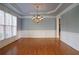 Dining room featuring classic hardwood floors, wainscoting, and a chandelier at 1037 Windermere Xing, Cumming, GA 30041