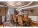 Formal dining room featuring a chandelier and decorative wall coverings at 1037 Windermere Xing, Cumming, GA 30041