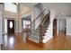 Grand foyer with hardwood floors, staircase with metal spindles and natural light at 1037 Windermere Xing, Cumming, GA 30041